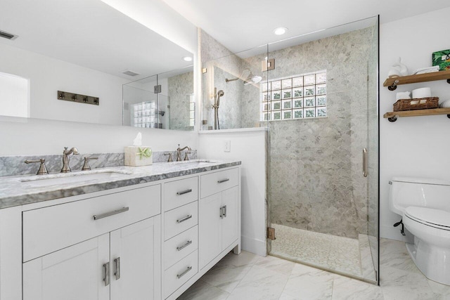 bathroom with walk in shower, vanity, and toilet