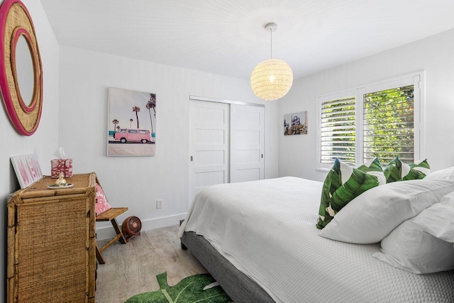 bedroom featuring a closet and light wood-type flooring