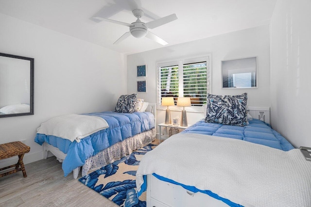 bedroom with ceiling fan and light hardwood / wood-style floors