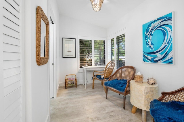 sitting room featuring vaulted ceiling and light hardwood / wood-style floors