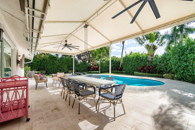 view of swimming pool featuring ceiling fan and a patio area