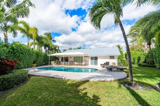 view of pool with a patio area, outdoor lounge area, and a lawn