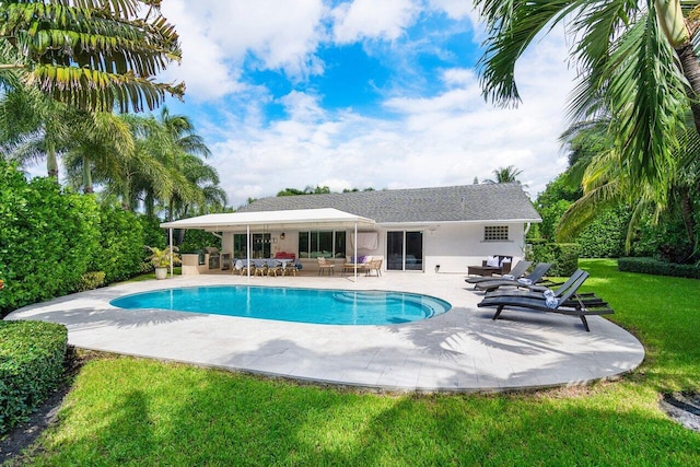 view of pool with a patio, outdoor lounge area, and a yard