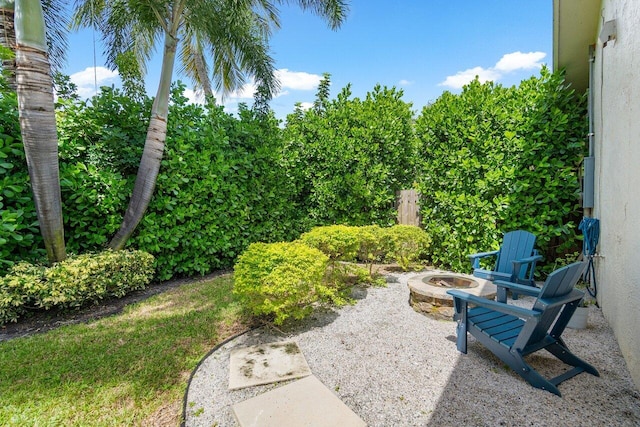 view of yard featuring a patio and an outdoor fire pit