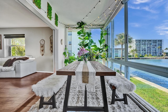 sunroom / solarium featuring plenty of natural light and a water view