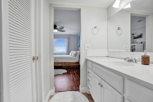 bathroom featuring ceiling fan, hardwood / wood-style floors, and vanity