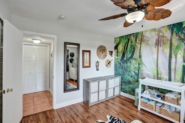 interior space featuring ceiling fan, a closet, and wood-type flooring