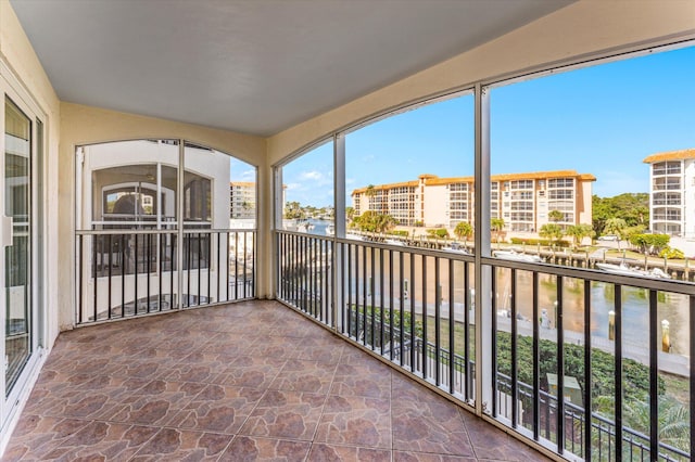 unfurnished sunroom with a water view