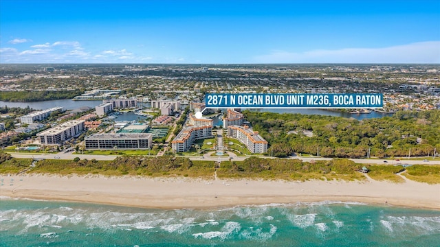 drone / aerial view featuring a beach view and a water view