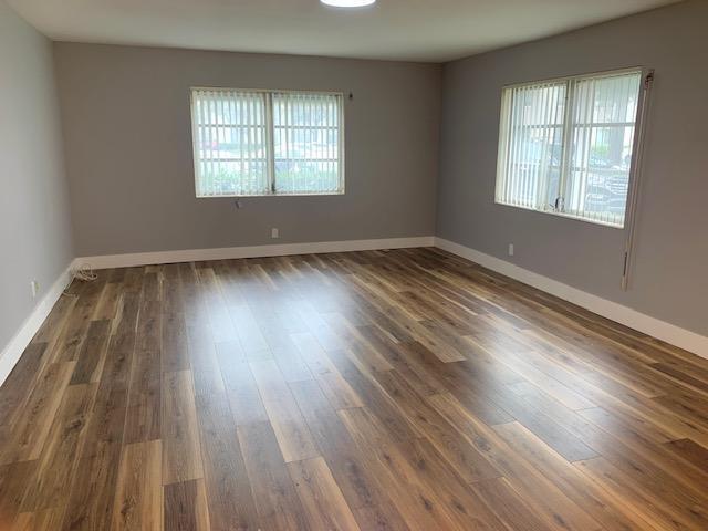 spare room with dark hardwood / wood-style floors