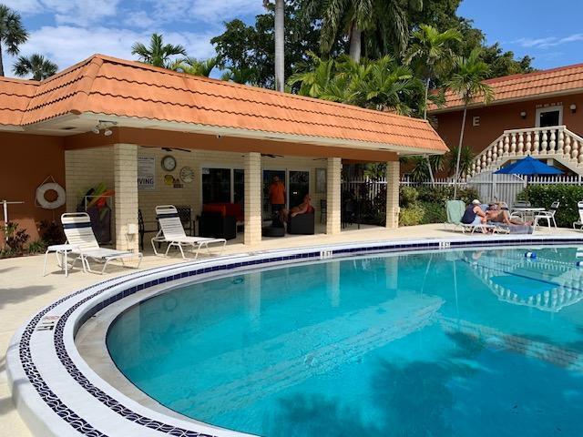 view of pool with ceiling fan and a patio area