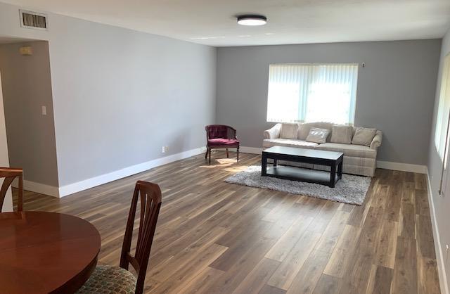 living room with dark hardwood / wood-style floors