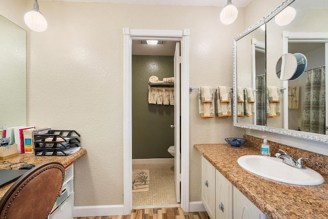 bathroom featuring toilet, a shower with shower curtain, vanity, and hardwood / wood-style flooring