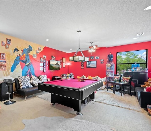 recreation room featuring a textured ceiling, ceiling fan, carpet floors, and billiards