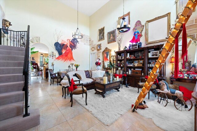 tiled dining area with an inviting chandelier and a towering ceiling