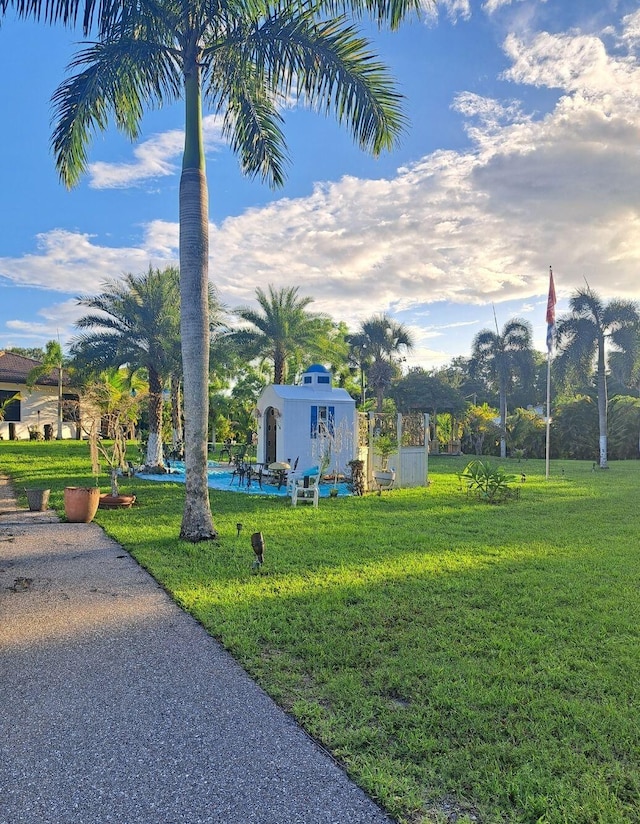 view of home's community with a yard