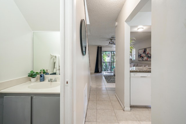 bathroom with a textured ceiling, ceiling fan, tile patterned floors, and vanity