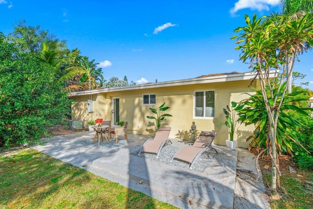 rear view of house featuring central AC and a patio