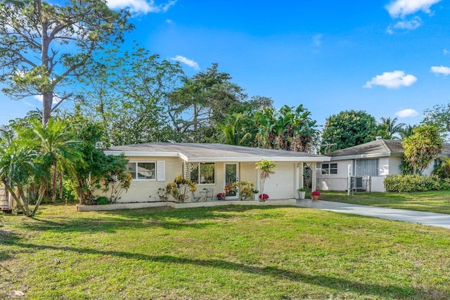 ranch-style home with a front yard and a garage