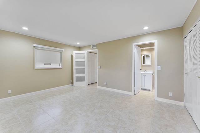 interior space with ensuite bathroom and a closet