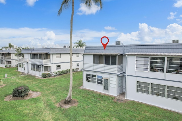 back of property featuring a lawn and central AC unit