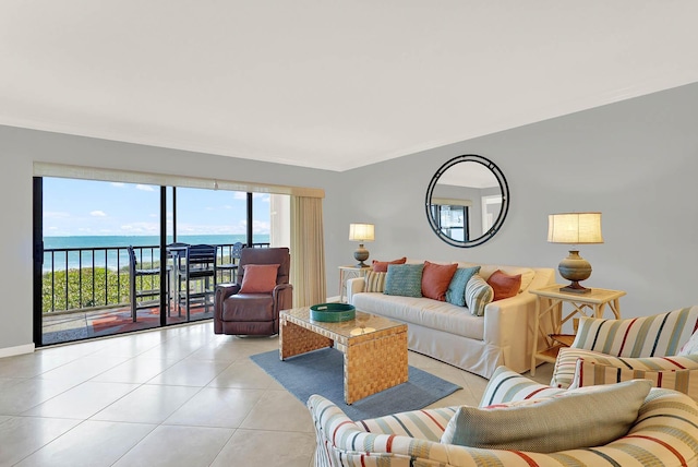 living room featuring light tile patterned flooring and a water view