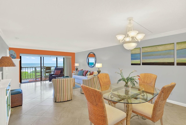 dining room featuring a water view, light tile patterned floors, a notable chandelier, and ornamental molding