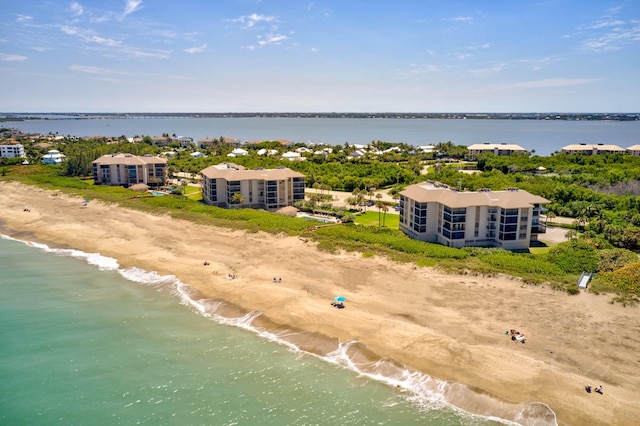 drone / aerial view featuring a beach view and a water view