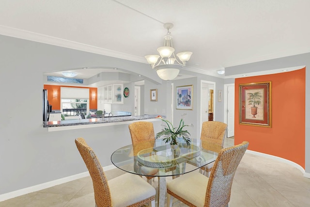 tiled dining space featuring ornamental molding