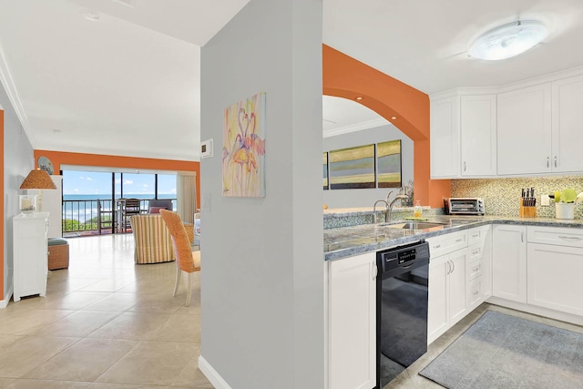 kitchen with light stone countertops, white cabinetry, dishwasher, and sink