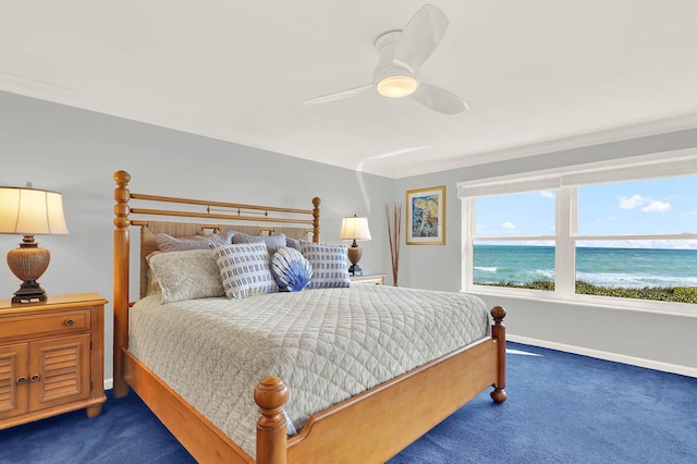 bedroom featuring ceiling fan, dark colored carpet, a view of the beach, ornamental molding, and a water view