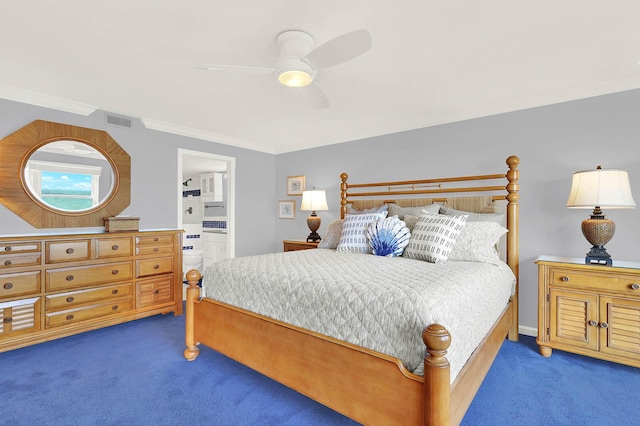 bedroom featuring ceiling fan, crown molding, ensuite bath, and dark colored carpet