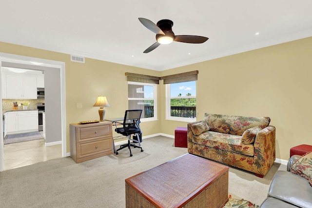 office featuring ceiling fan, crown molding, and light carpet