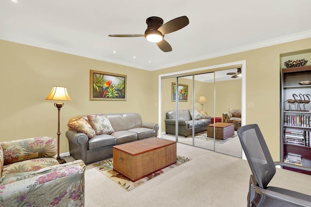 carpeted living room with ceiling fan and ornamental molding