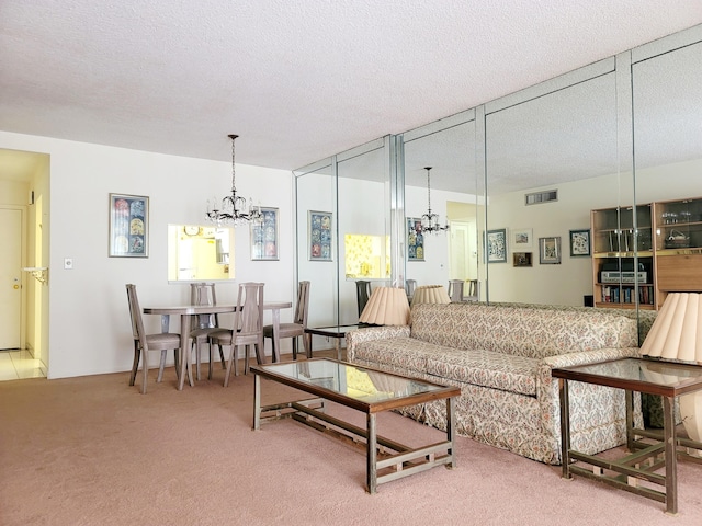 carpeted living room featuring an inviting chandelier and a textured ceiling