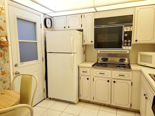 kitchen featuring white appliances and light tile patterned floors