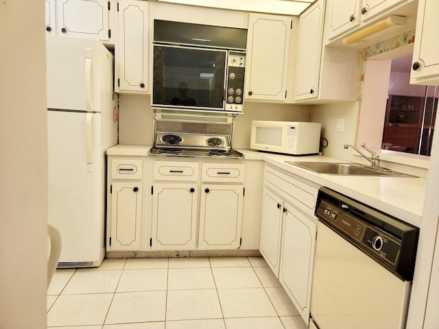 kitchen with light tile patterned flooring, white appliances, and sink