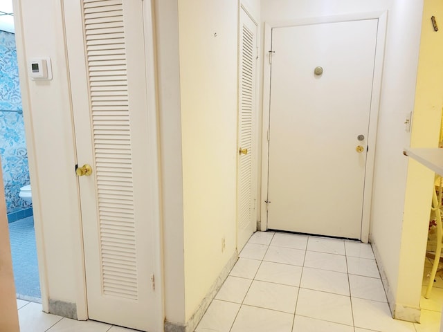 corridor featuring light tile patterned floors