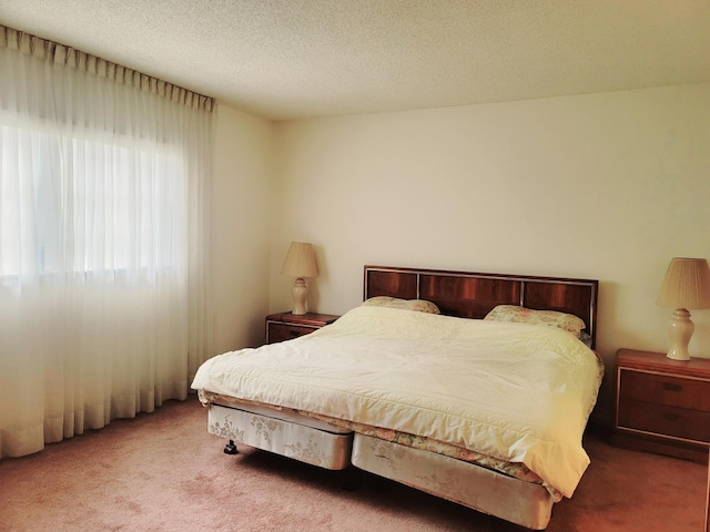 carpeted bedroom featuring a textured ceiling