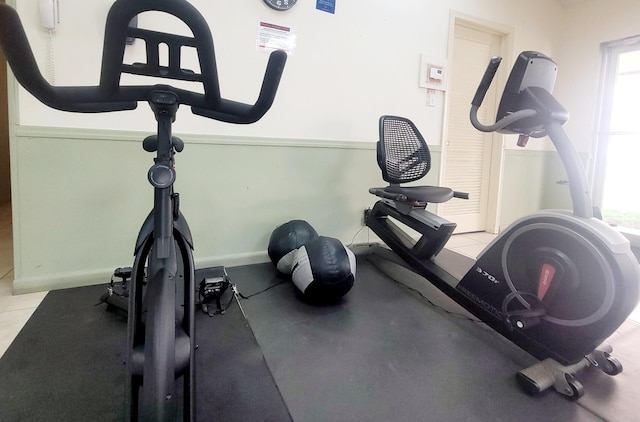 workout area featuring light tile patterned flooring and a wealth of natural light