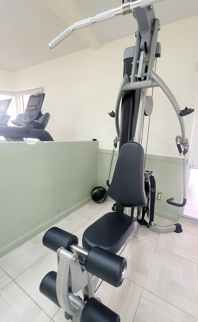 workout area with light tile patterned flooring