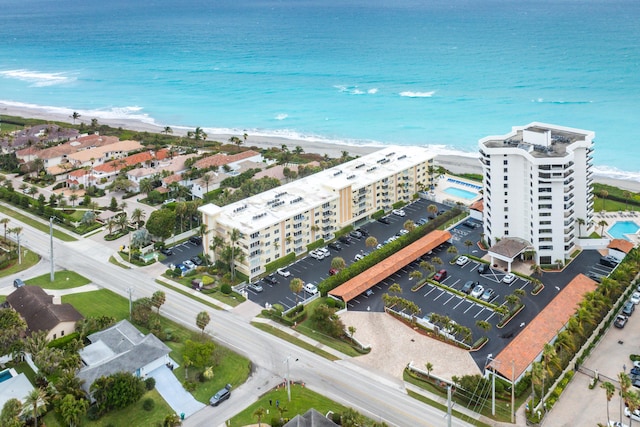 aerial view with a water view and a view of the beach