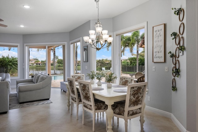 dining space with a water view and a chandelier