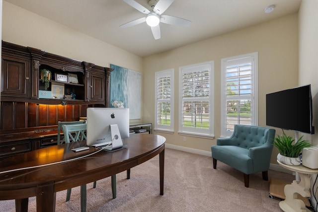 office space featuring light carpet and ceiling fan