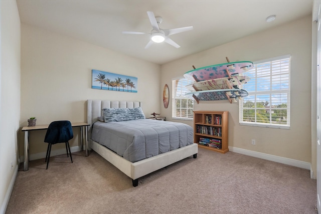 bedroom featuring ceiling fan and carpet