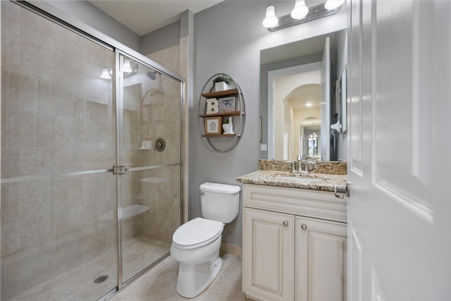 bathroom featuring walk in shower, tile patterned floors, vanity, and toilet