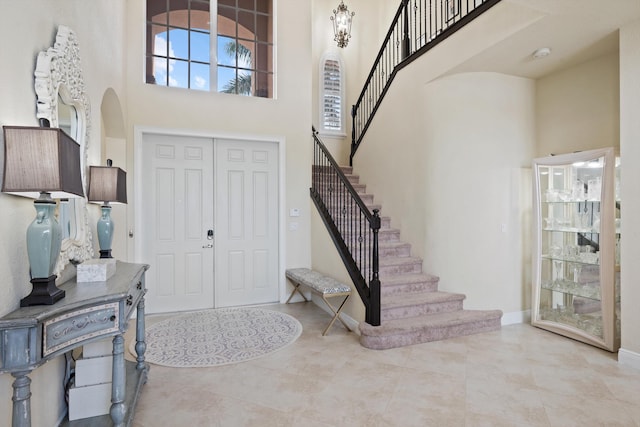 foyer entrance with a towering ceiling