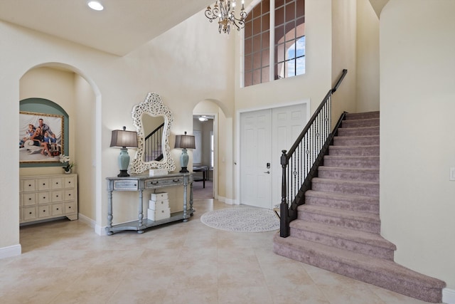 entrance foyer featuring an inviting chandelier and a high ceiling