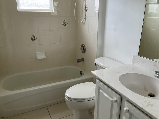 bathroom featuring tile patterned flooring, shower / washtub combination, toilet, and vanity