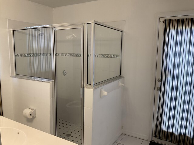 bathroom featuring a stall shower and tile patterned flooring